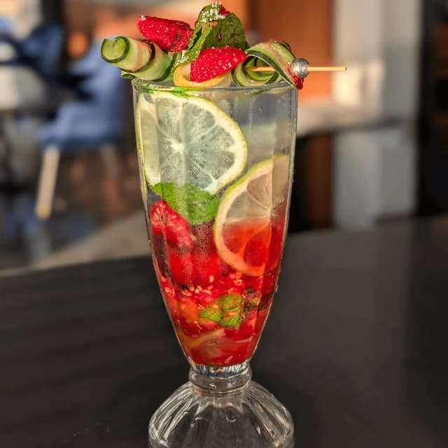 Chef preparing food on a griddle.